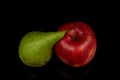 Red apple and green pear on a black background. Water droplets on fresh fruit Royalty Free Stock Photo
