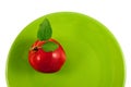 Red apple on a green plate Royalty Free Stock Photo