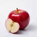 A red apple with half cut open and leaf in the rind Royalty Free Stock Photo