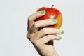 Red apple in hand with manicure. female hands. beauty salon woman shellac polish Royalty Free Stock Photo