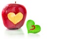 Red apple and the heart which is cut out from apple Royalty Free Stock Photo