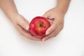Top view of female hands holding red apple isolated on white Royalty Free Stock Photo