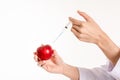 Red apple injections needle or syringe and chemical concept on white background Royalty Free Stock Photo