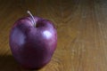 Red apple on dark brown background