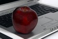 Red apple and laptop close-up Royalty Free Stock Photo