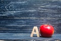 Red apple and letter A. The concept of primary education. Apple for the teacher. Sadik, school, college, university, educational i Royalty Free Stock Photo