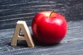 Red apple and letter A. The concept of primary education. Apple for the teacher. Sadik, school, college, university, educational i Royalty Free Stock Photo