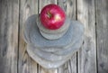 Red apple lies on top of a pebble pyramid. Royalty Free Stock Photo
