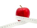 Red apple and measure tape centimeter that represent reduce weight or diet food and exercise for body good shape design concept Royalty Free Stock Photo