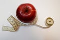 Red apple with measure tape on white background Royalty Free Stock Photo