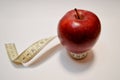 Red apple with measure tape on white background Royalty Free Stock Photo