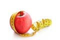 Red apple with measuring tape isolated on white background. Healthy lifestyle, diet concept Royalty Free Stock Photo