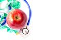 Red apple, measuring tape and stethoscope on white background Royalty Free Stock Photo