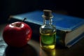 Red apple and natural oil bottle near the blue covered book. Generate ai