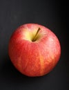 Red apple over black. Fresh organic fruits. Delicious and healthy.