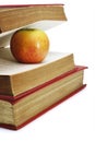 Red apple in between pages of old book Royalty Free Stock Photo