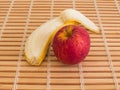 Red apple and peeled banana close up view Royalty Free Stock Photo