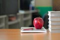 Red apple on a pile of books, paper and pencil on the desk, Educational concept Royalty Free Stock Photo