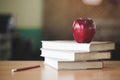 Red apple on a pile of books, paper and pencil on the desk, Educational concept Royalty Free Stock Photo