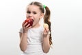 Red apple and potato chips, healthy and unhealthy food for children, little girl makes a choice between healthy and Royalty Free Stock Photo
