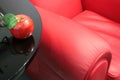 Red apple and a red easy chair Royalty Free Stock Photo
