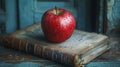 A Red Apple Resting on an Old Leather-Bound Book Royalty Free Stock Photo