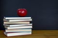 Red Apple on School Books with copy space on chalk board