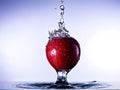 Red Apple Splashing in Water Royalty Free Stock Photo