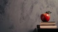 A red apple sitting on top of a stack of books Royalty Free Stock Photo