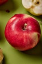 Red apple slices isolated on green background with clipping path and full depth of field Royalty Free Stock Photo