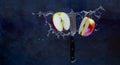 Red apple slices in water splash cut with fruit Knife. Copy space Royalty Free Stock Photo