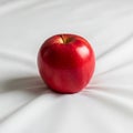 Fabric has soft folds, creating gentle shadows around the apple. The Royalty Free Stock Photo