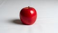 Red apple with a smooth, shiny surface sits on a plain, white background. The apple is round and Royalty Free Stock Photo