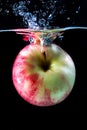 Red apple spash in water on black Royalty Free Stock Photo