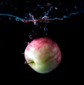 Red apple spash in water on black Royalty Free Stock Photo