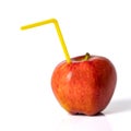 Red apple with a straw for a cocktail on a white background. Royalty Free Stock Photo