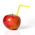 Red apple with a straw for a cocktail on a white background. Royalty Free Stock Photo