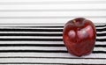 Red apple on the stripey background Royalty Free Stock Photo