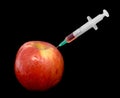 Red apple with a syringe Royalty Free Stock Photo