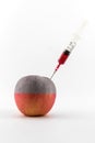 Red apple with a syringe. Royalty Free Stock Photo