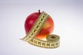 Red Apple and tape measure on white background Royalty Free Stock Photo