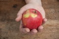 Red apple temptation concept on wooden table Royalty Free Stock Photo