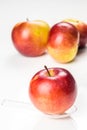 Red apple on translucent medicine spoon on the table