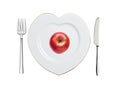 Red apple on white plate in shape of heart, spoon and fork isolated on white