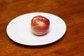 Red Apple on White Plate Royalty Free Stock Photo