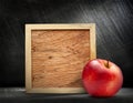 Red apple with wooden frame Royalty Free Stock Photo