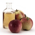 Red apples and apple vinegar in glass bottle on white Royalty Free Stock Photo
