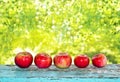 Red apples on a blue old wooden table. Royalty Free Stock Photo