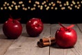 Red apples and cinnamon sticks on the background of Christmas lights, apple pie recipe Royalty Free Stock Photo