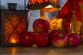 Red apples, orange lantern, a bottle of sunflower oil, ears of w